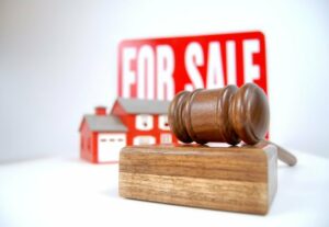 House auction concept shot with a sign, home and gavel